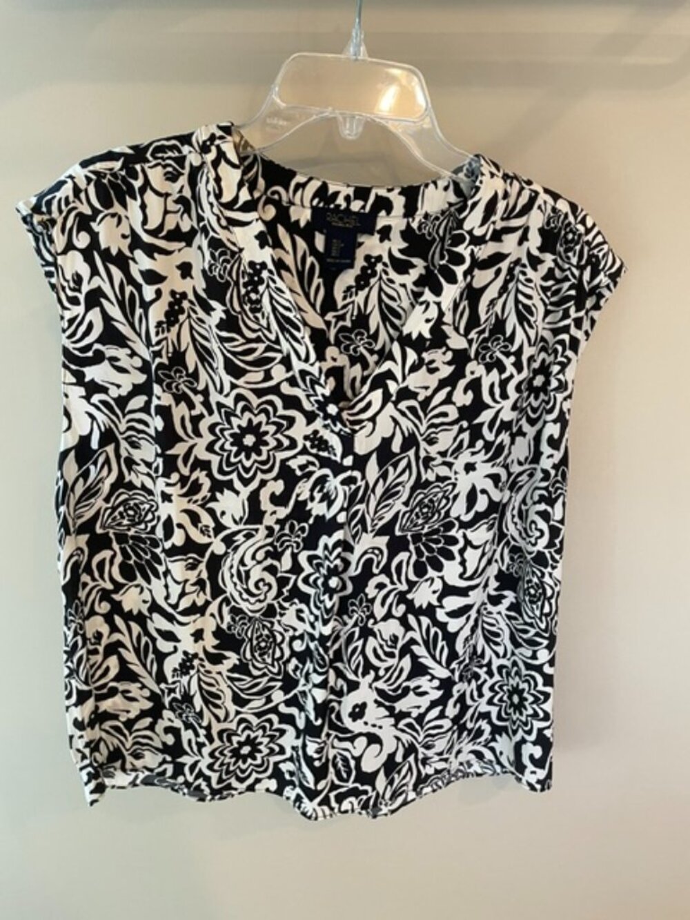 Women's Rachel sleeveless blouse with V-neck front in cream and black.